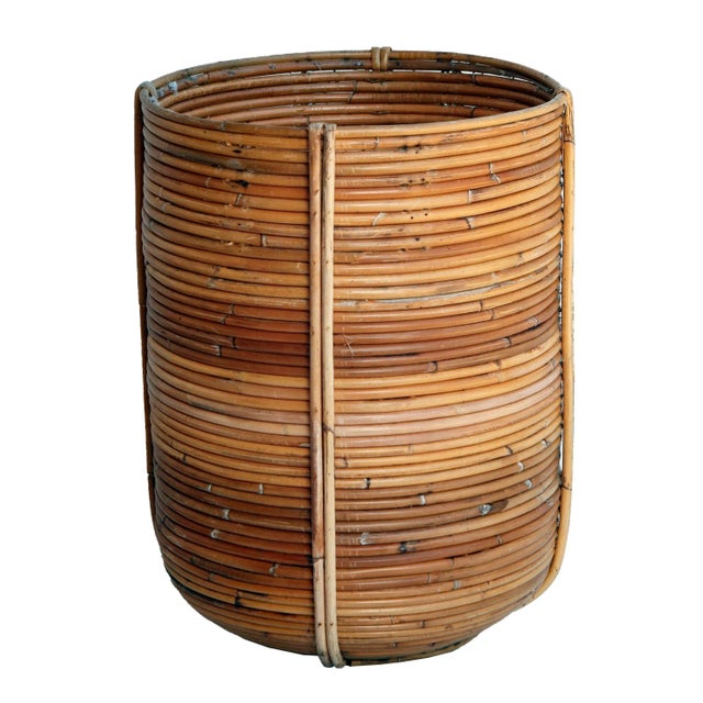 Hand woven reed basket with natural texture and color. Crafted in the mid 20th century, it features an organic silhouette...