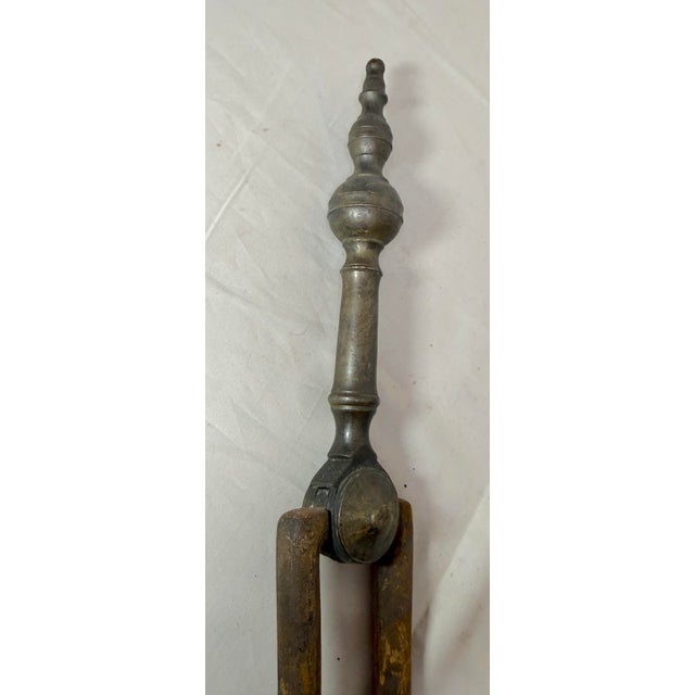 Up for sale is a pair of rare antique 18th century wrought iron and brass English fireplace tongs. The arms are wrought by...