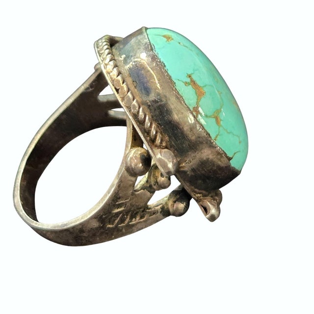 The artistry of Navajo culture shines in this sterling silver ring featuring a striking Royston turquoise stone. Its...