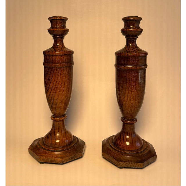 Deeply grained wood in a satin medium toned walnut finish encompasses this pair of solid oak wood candlesticks. Believed...