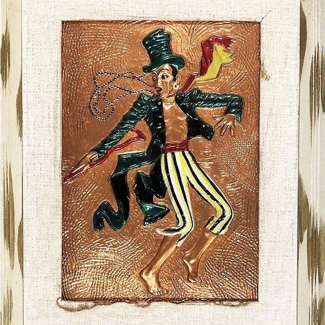 Copper Embossed Dancing Man wall sculpture, in original white painted wood frame. The wall art shows a ring master wearing...
