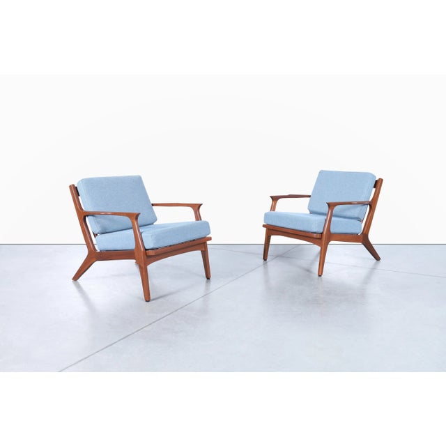 These Danish modern walnut lounge chairs embody the refined craftsmanship and sculptural simplicity that made Scandinavian...