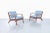 These Danish modern walnut lounge chairs embody the refined craftsmanship and sculptural simplicity that made Scandinavian...
