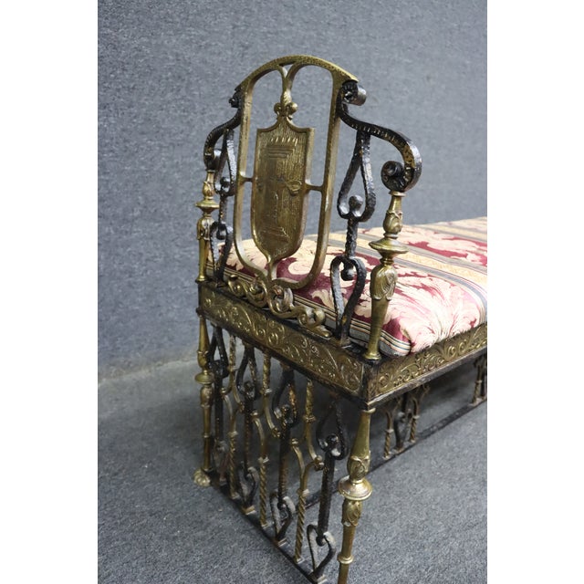 An Oscar Bach attributed gilt bronze and wrought iron bench featuring an upholstered seat with decorative scrolling...