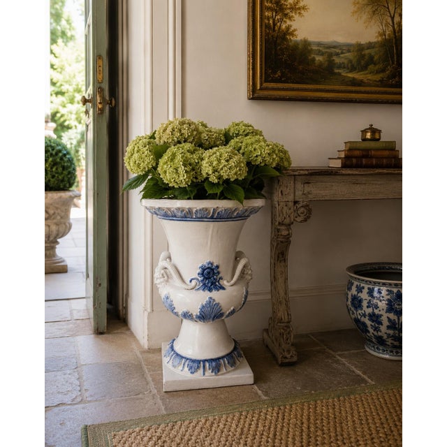 A monumental late 19th century blue and white majolica Grecian urn with extraordinary mythological presence. The body is...