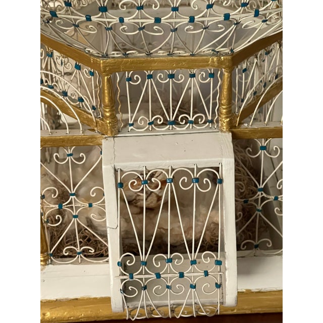 Ornate antique wire and wood architectural bird cage. With feathered birds and bleeding hearts vine. Great decor or...