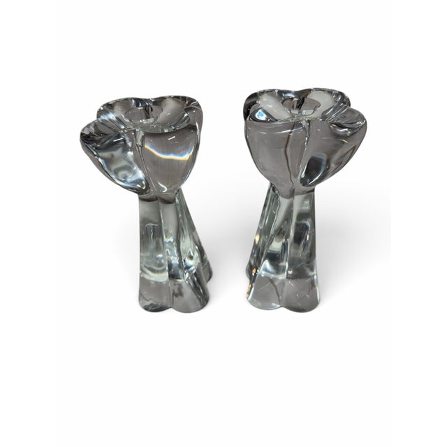 A breathtaking duo of authentic French luxury. This matched pair of heavy, clear crystal candlesticks features the highly...