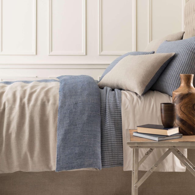 Precisely crafted black pick stitch accentuates the yarn dyed cotton jacquard of this reversible matelassé coverlet. The...