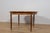 This round extendable dining table was produced by G-Plan in the 1960s. The table has profiled reinforced edges of the...