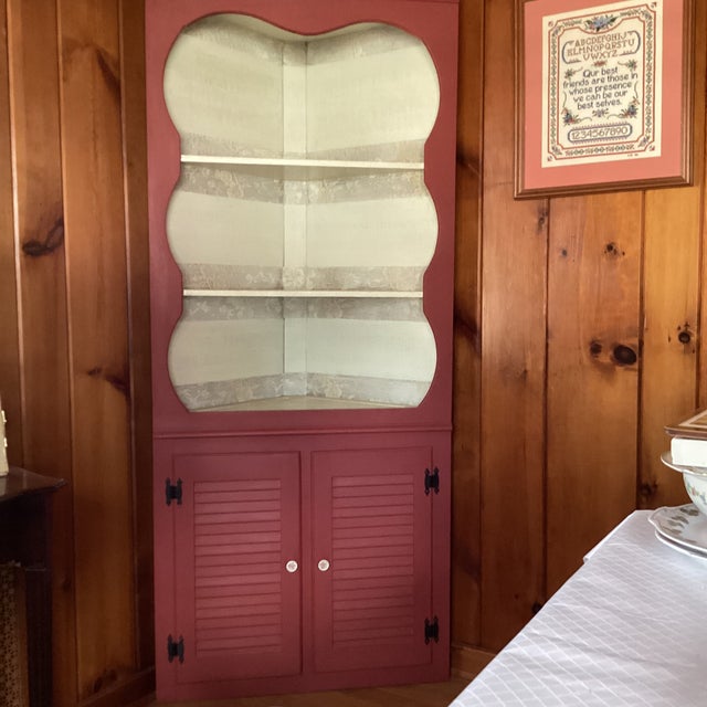 This is a charming cabinet of the 1950's era sold as "unpainted pine". It was painted on the exterior with a colonial rose...
