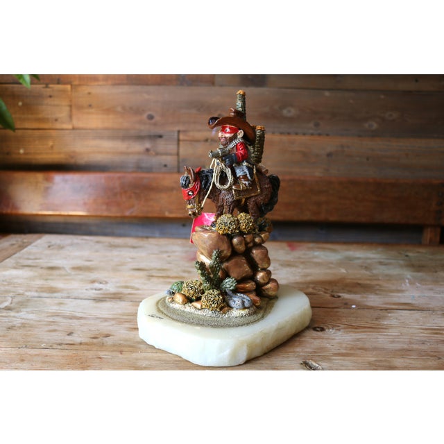 Stunning sculpture resembles the "Cactus Pete" by Ron Lee, original from the 1989. A cowboy-on-horse sculpture, which also...