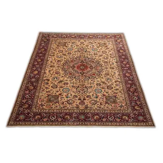 ACTUAL SIZE: 10’1″ x 13’7″ PRIMARY COLOR: Gold / Burgundy AGE: Old MATERIALS: Wool FOUNDATION: Cotton PRODUCTION:...