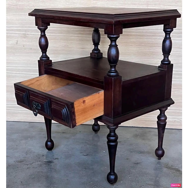 20th century Pair of solid carved Spanish nightstands with one low carved drawer with original bronze pull.