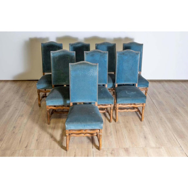 This set of eight 20th-century French mutton-leg side chairs features a classic design inspired by Louis XIII aesthetics....