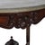 An antique Victorian parlor table offers shaped and beveled marble top over walnut base having carved foliate, nut and...