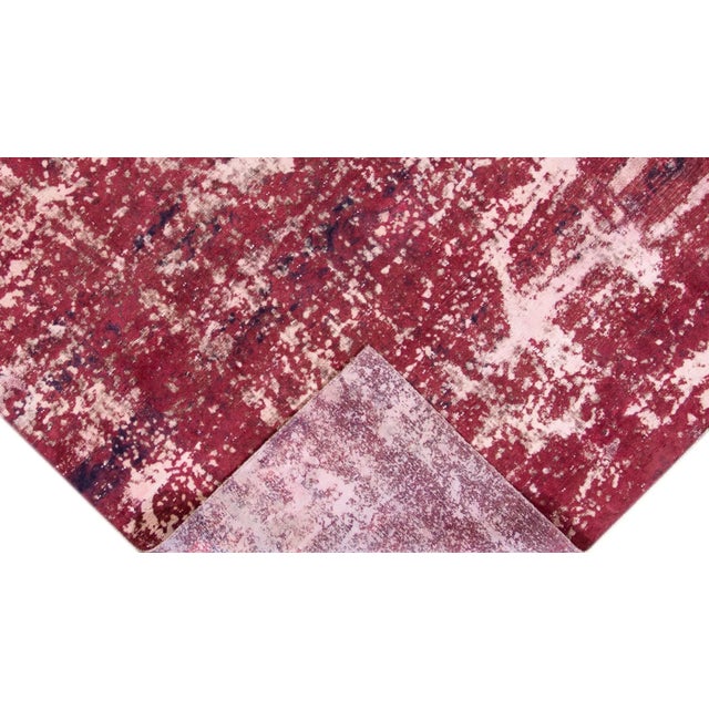 Beautiful vintage Distressed Overdyed hand-knotted wool rug with a ruby-red field. This piece has black and ivory accents...