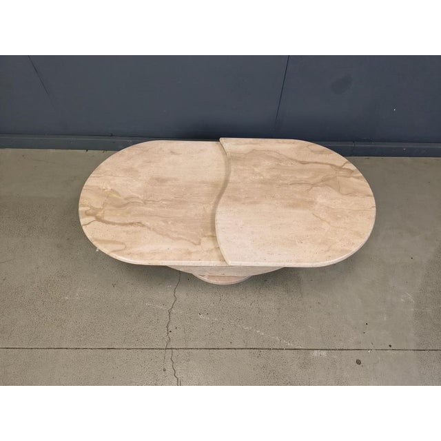 Timeless travertine coffee table with two nicely shaped tops. The tops can be turned around to create a different look....