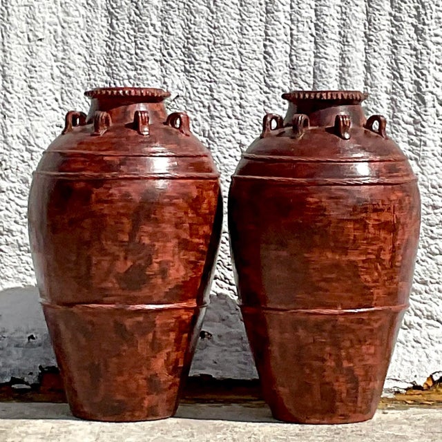 A fabulous pair of vintage Boho urns. Chic hand painted finish in a warm brownish rust color. Perfect indoors or outside...