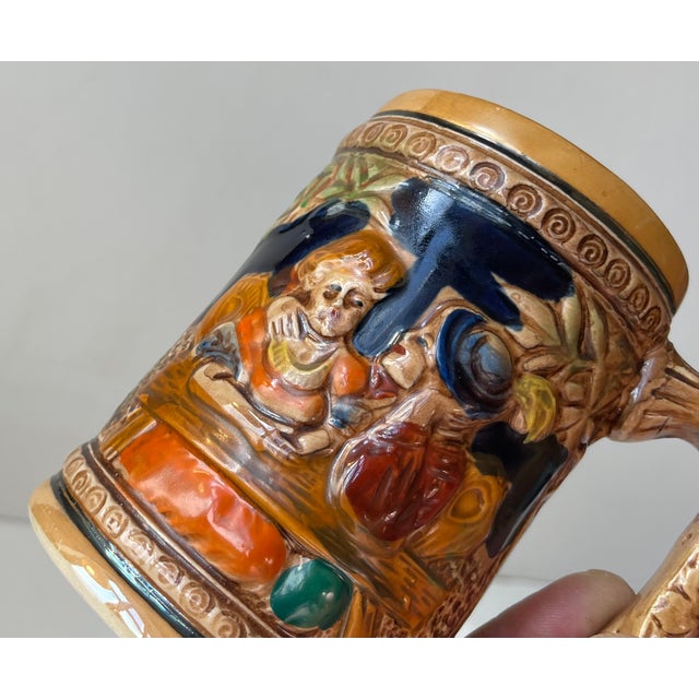A set of German beer mugs or Bier Steins decorated with jolly medieval pub scenes and sceneri in relief. These were not...