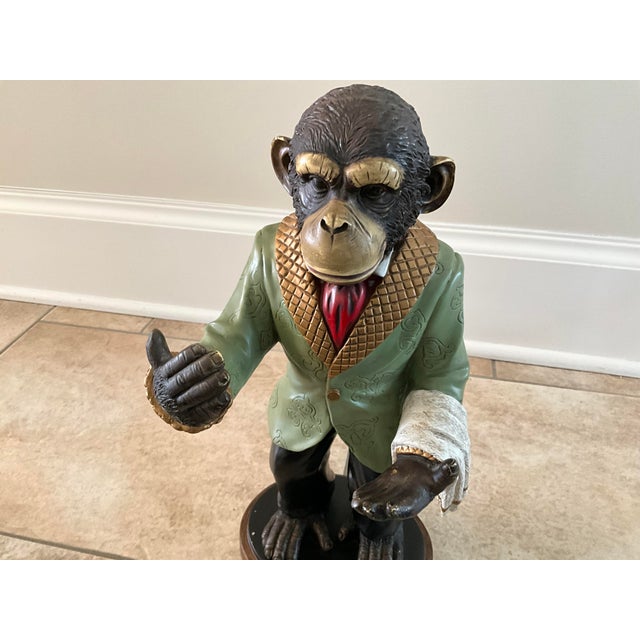 Vintage wine holder by Bombay Co. crafted as "Winston, the Butler Chimpanzee" wearing a coat, tie, and pants with hands...