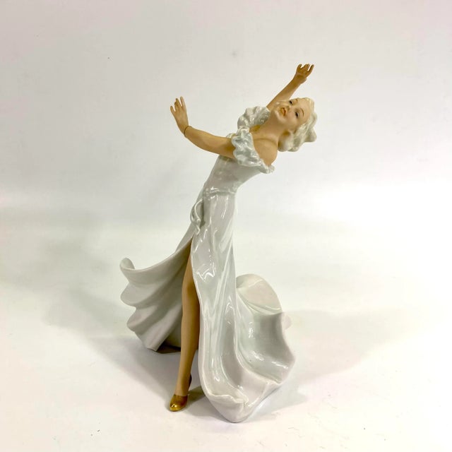 A beautiful figurine of a dancing woman wearing gold shoes! This is made from Goebel West Germany.