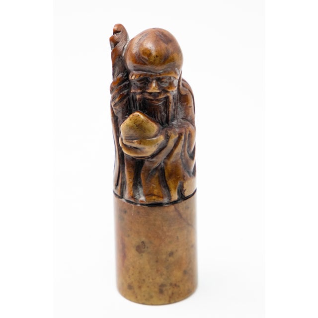 Offering this Chinese chop seal. On top it depicts Shoulao, God of Longevity. He sits atop a cylindrical short base. He is...