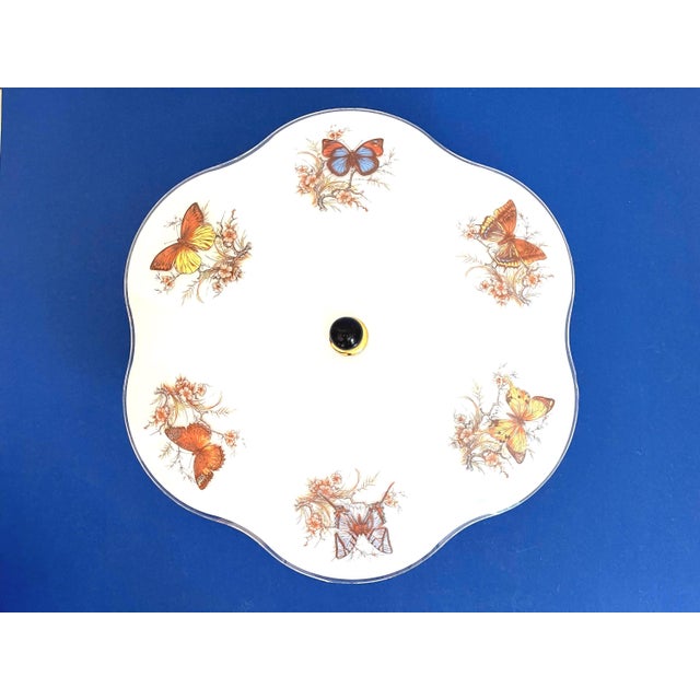 Lovely mid century frosted glass ceiling light accented by a ring of colorful butterflies on flowering branches with airy...