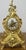 An elegant Vintage brass clock featuring a beautifully ornate Rococo-inspired design with flowing curves, pierced...