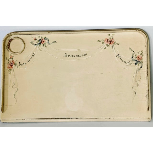 This charming French bed tray has been hand painted with flowers and ribbons and welcoming messages that translate to;...