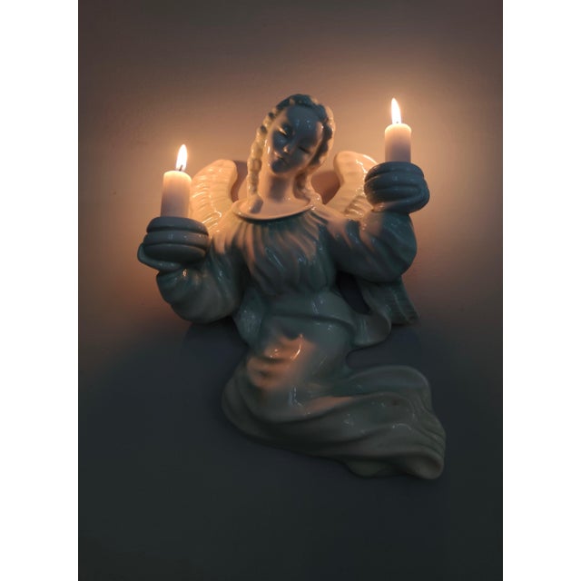 Made in Wien, Austria, 1930s. It is made in white glazed ceramic. This candleholder is vintage, therefore it might show...