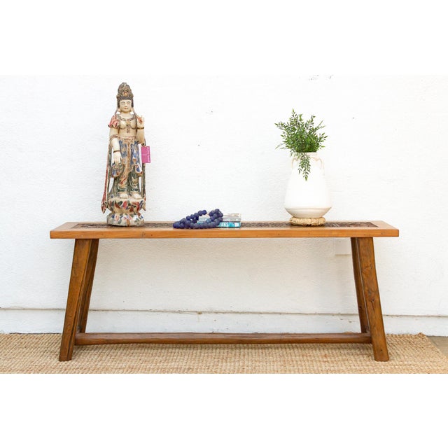 This rustic console table is a true work of art, featuring a stunning antique panel inlaid into its sturdy top. The panel...