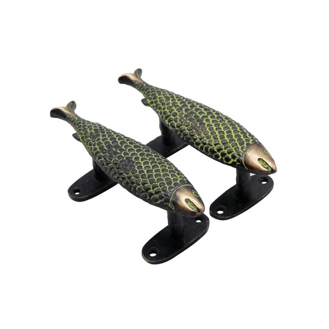 A pair of green colored brass fish door handles or cabinet pulls. Cast with intricate details throughout. Dimensions per...