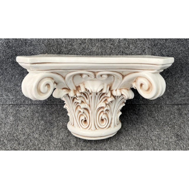 This vintage Italian-made porcelain wall sconce features a classical Corinthian-inspired form with deeply molded acanthus...