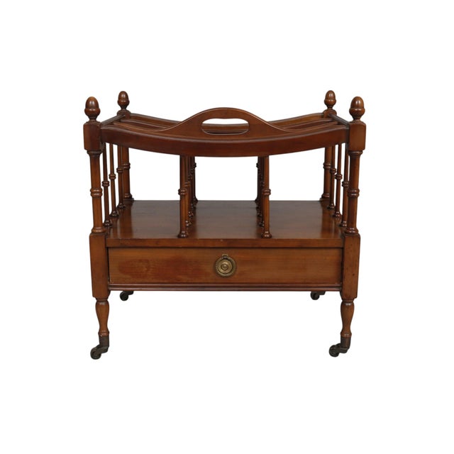 A colonial style canterbury in mahogany, circa 1940, made by Columbia Manufacturing Company. The elegant frame is carved...
