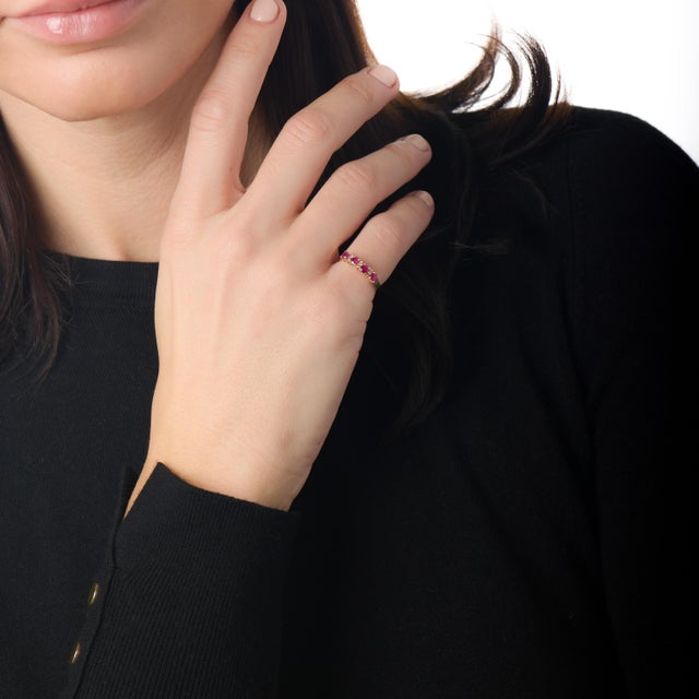 This elegant vintage ruby and diamond band offers a refined balance of color and sparkle, reflecting the understated...