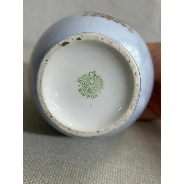 Bring early 20th-century elegance into your space with this exquisite antique hand-painted porcelain twin-handled vase by...
