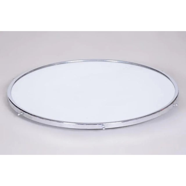 Well preserved condition with mirrored glass and chrome plated steel.