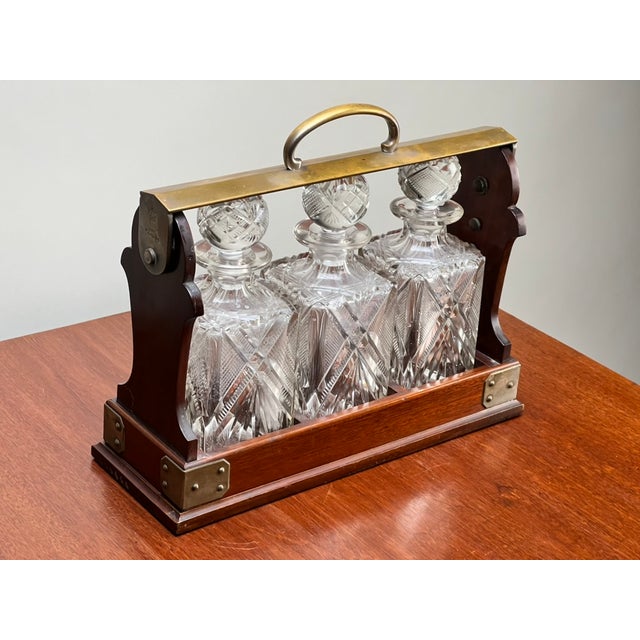 This wonderful antique English Edwardian tantalus dates to the early 20th century and is a beautiful example of the...