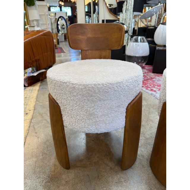 This striking pair of sculptural solid-wood frames with softly curved backrests, paired with newly reupholstered seats in...