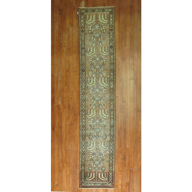Decorative Persian Heriz one-of-a-kind antique narrow runner from the early 20th century. in brown and green. Measures:...