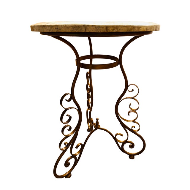 Gorgeous travertine top accent table atop curved and wrought iron with a bronzed finish. Elegant and versatile, a table...