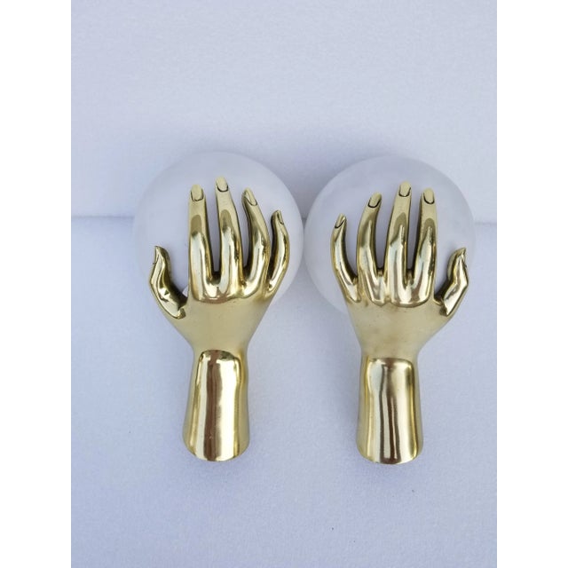 Superb and very rare in bronze color pair of hands sconces by Maison Arlus. Model number 1436, figuring a bronze hand...