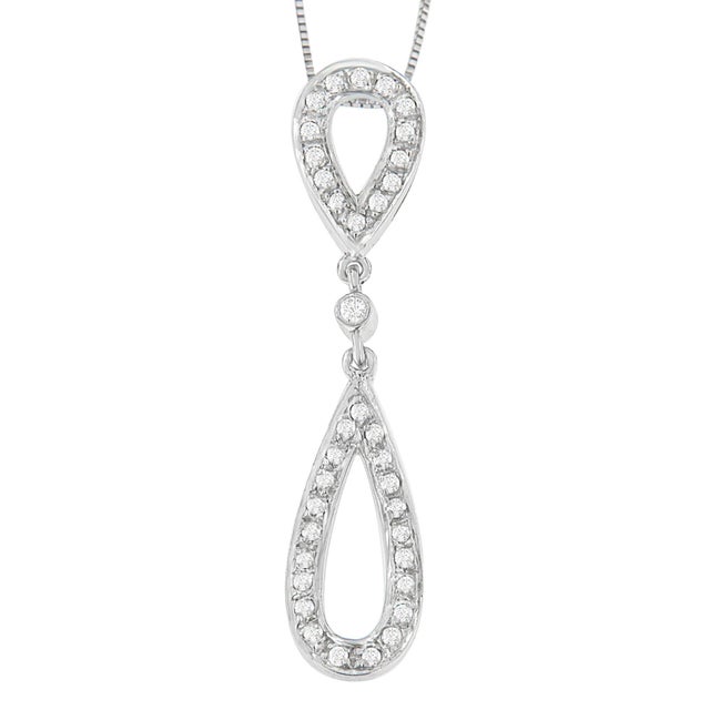 The beauty of this pendant is in the details. A modern 14 karat white gold setting connects two tear drop shapes at top...