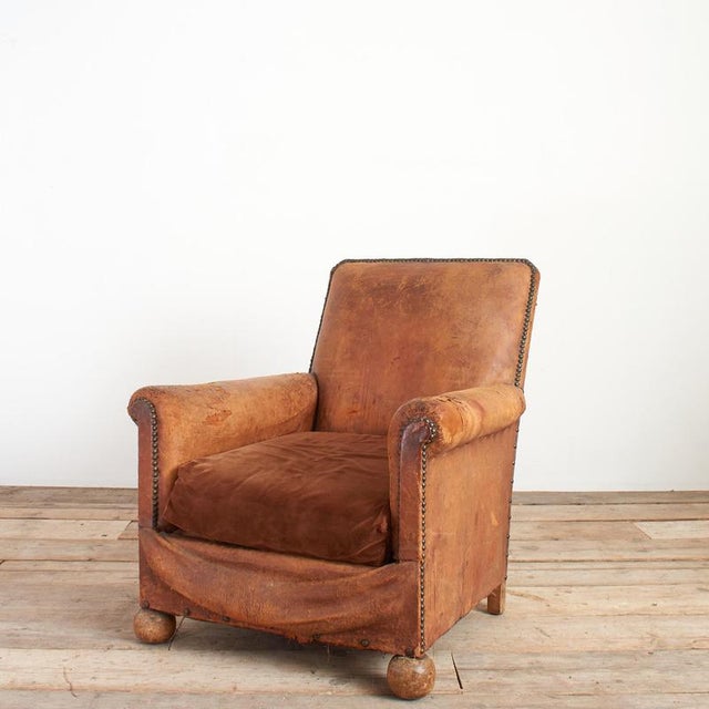An early twentieth century French leather club armchair. It has a great patina consistent with age and use. The chair...