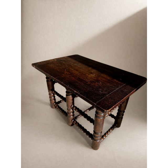 This exceptional and highly characterful console table is crafted from solid oak, boasting an incredibly deep, rich...