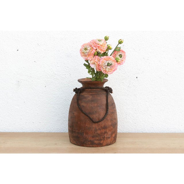 Originally used in village homes for storing milk, ghee, or grains, this antique wooden pot has survived generations of...