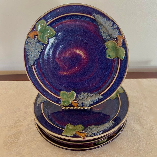 This is an unusual find - a complete set of 4 dinner plates made in 1976 in bold blue by Al Podesto Pottery from...