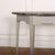Small 19th century English console table with a brown and grey flecked marble top. 1900. This piece is designed in the...