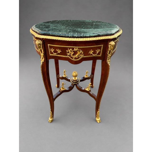 This elegant 1960s French Louis XVI–style table combines rich mahogany, green Italian marble and finely detailed gilt-...
