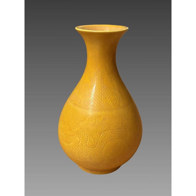 Monochrome yellow porcelain vase - China, Qing Dynasty. Yellow glazed porcelain with underglaze incision depicting a...